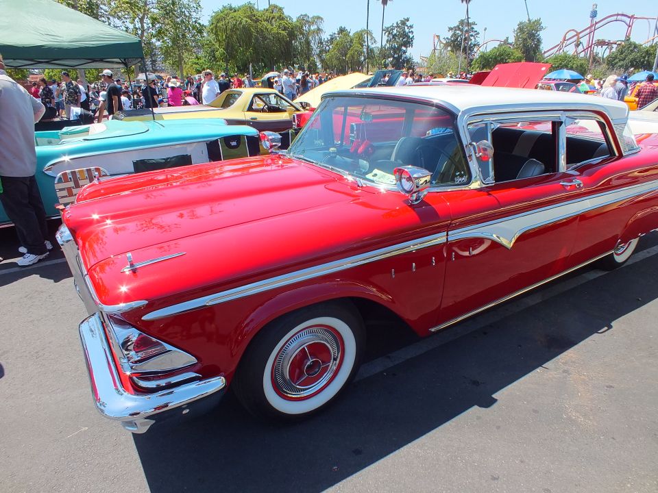 Red and white 1959 Edsel hardtop with whitewall tires at a car show
