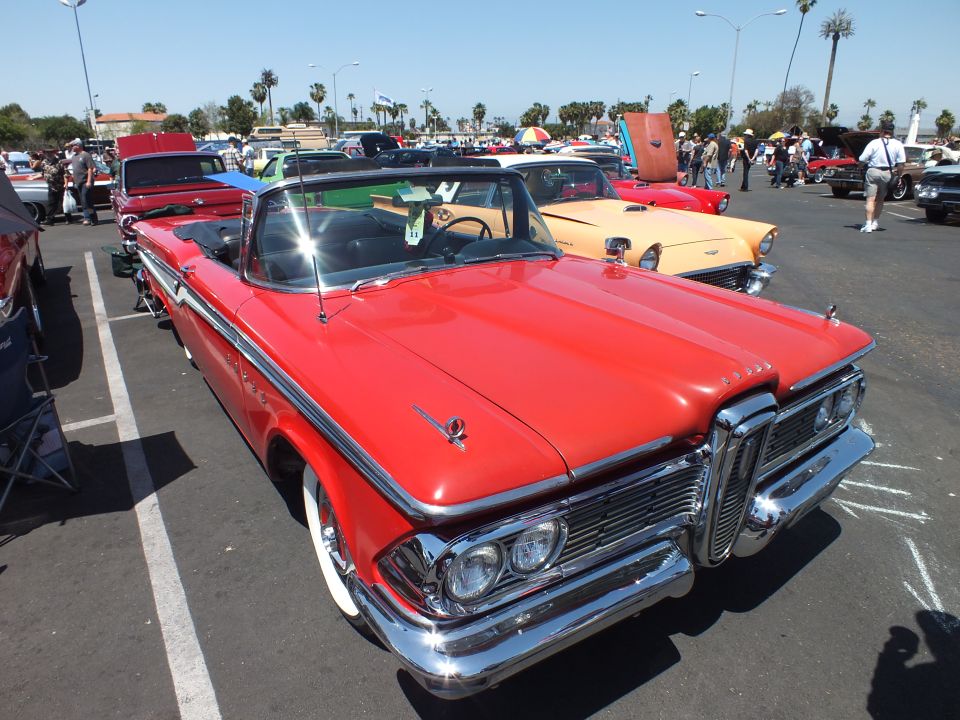 Red 1959 Edsel convertible with top down at a sunny car show