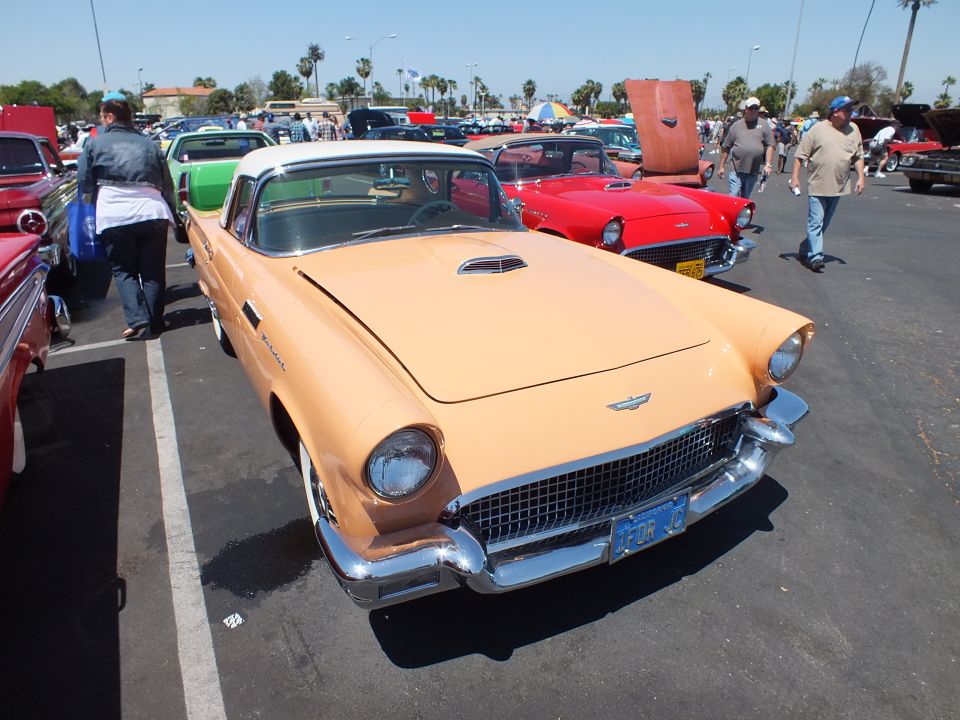 Tan two-tone Ford Thunderbird hardtop with porthole roof at a car show