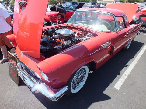Red Ford Thunderbird with wire wheels, hood up showing V8 engine