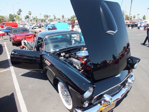 Black Ford Thunderbird hardtop with hood and door open and wire wheels