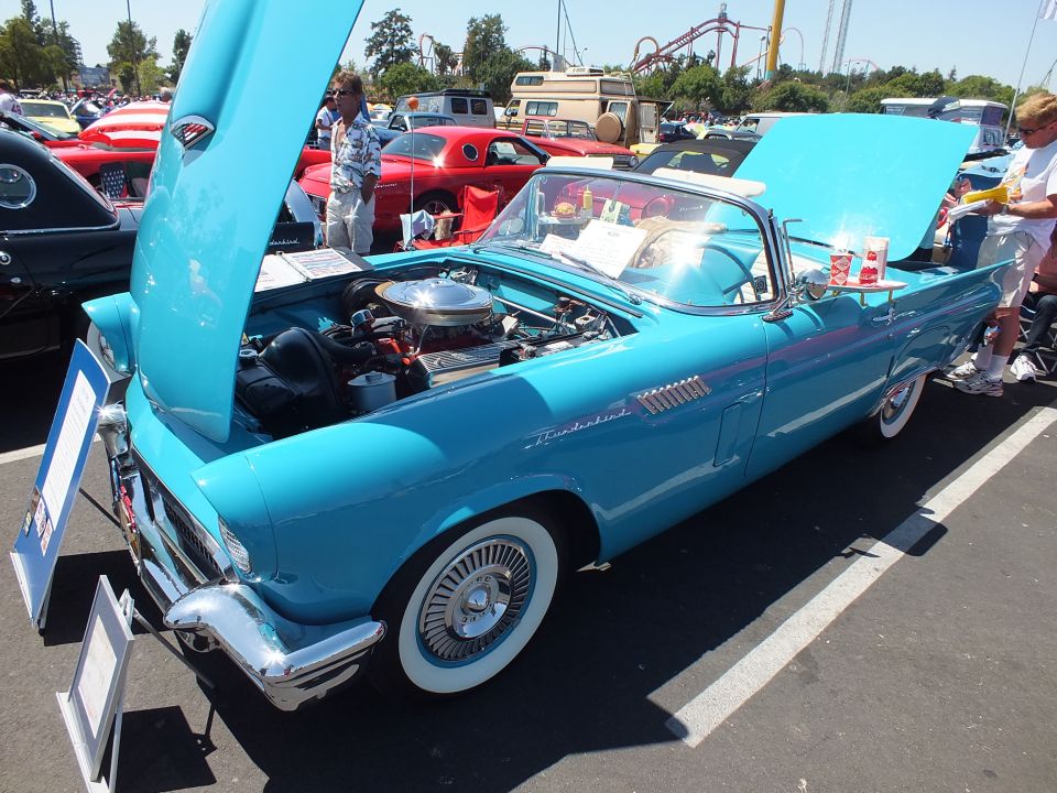 Turquoise Ford Thunderbird convertible with hood up and whitewall tires