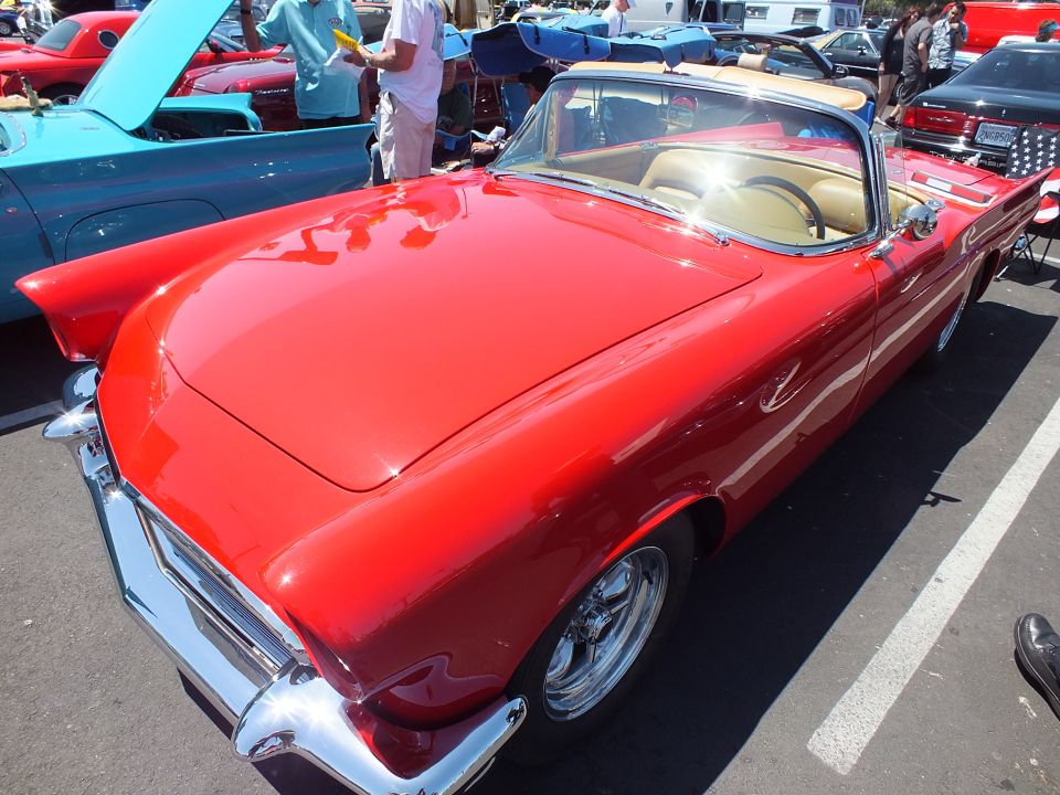 Red Ford Thunderbird convertible with tan interior viewed from front