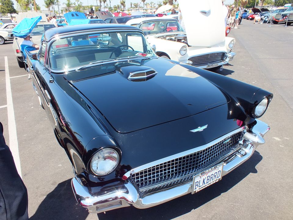 Black Ford Thunderbird with BLKBRRD plate and chrome grille at car show
