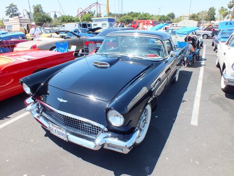Black Ford Thunderbird with hood scoop and California plate at car show