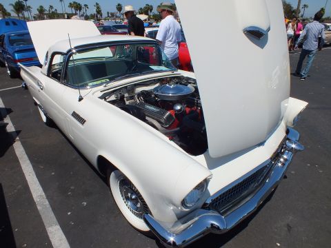 White Ford Thunderbird hardtop with hood up showing V8 at car show