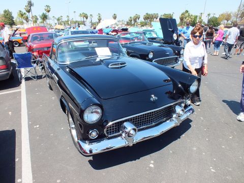 Black Ford Thunderbird with crossed-flags emblem and chrome grille
