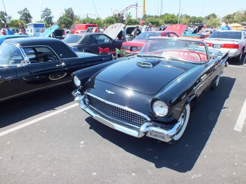 Black Ford Thunderbird convertible with red interior and chrome grille