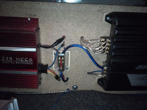 2000 Mercury Grand Marquis - Close-up of car audio amplifiers and their wiring, including a fuse holder.