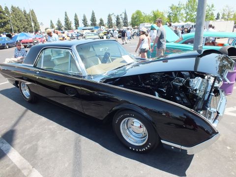 Black Ford Thunderbird coupe with open hood and Goodyear tires