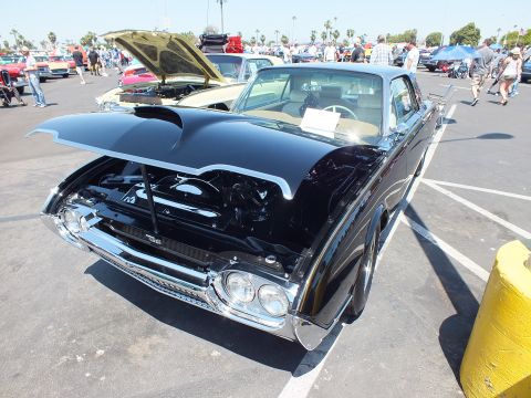 Black Ford Thunderbird with hood open showing chrome engine