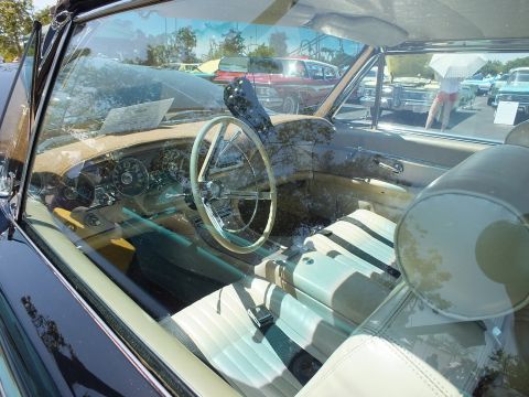Interior through windshield of classic car with white seats