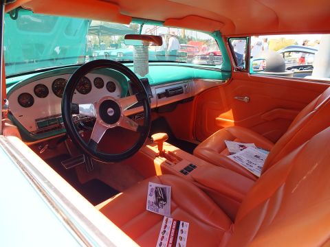 Custom interior with orange seats and white dash, turquoise body