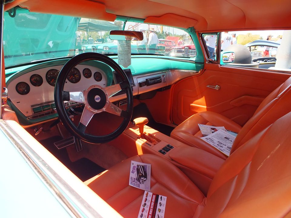 Custom interior with orange seats and white dash, turquoise body