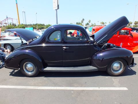 Dark purple 1940 Ford coupe hot rod side profile at car show