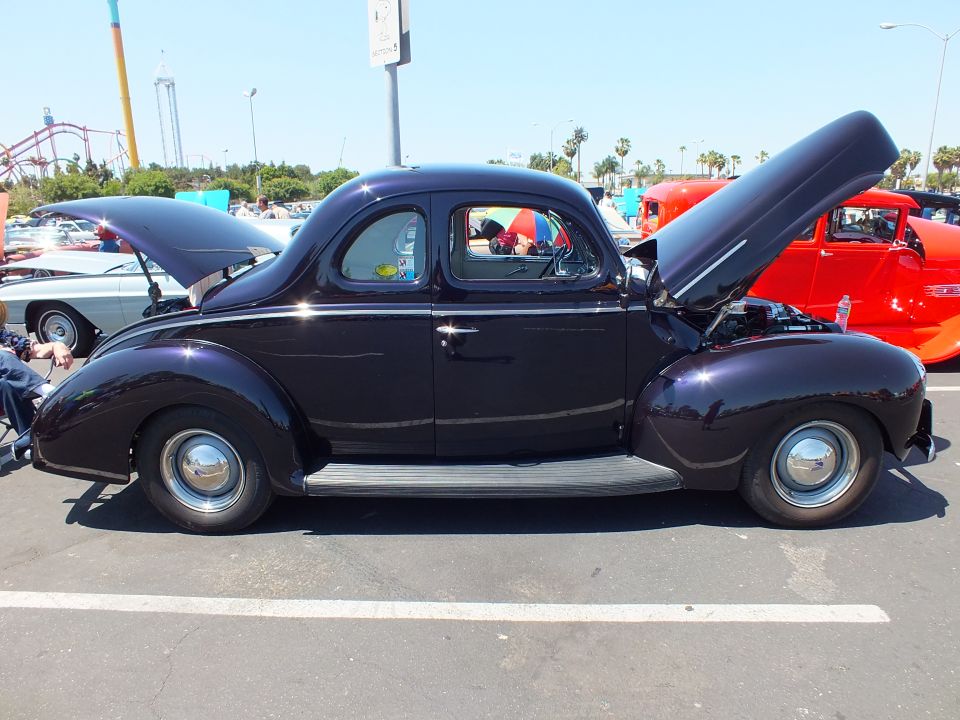 Dark purple 1940 Ford coupe hot rod side profile at car show