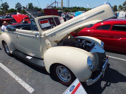 Cream 1940 Ford convertible with raised hood, For Sale sign and Ford info placard at show