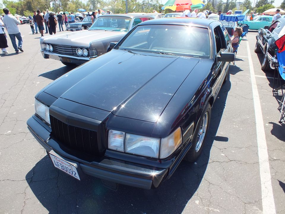 Front of dark Lincoln Mark VII coupe with vertical grille and amber turn signals
