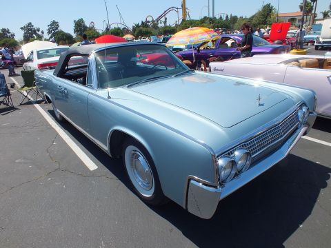 Light blue 1960s Lincoln Continental convertible with top up at car show