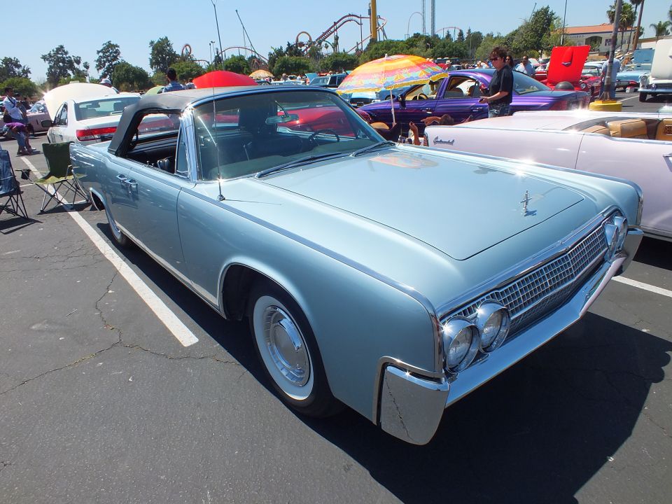 Light blue 1960s Lincoln Continental convertible with top up at car show