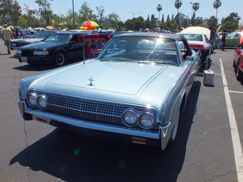 Front of light blue 1960s Lincoln Continental convertible with chrome grille