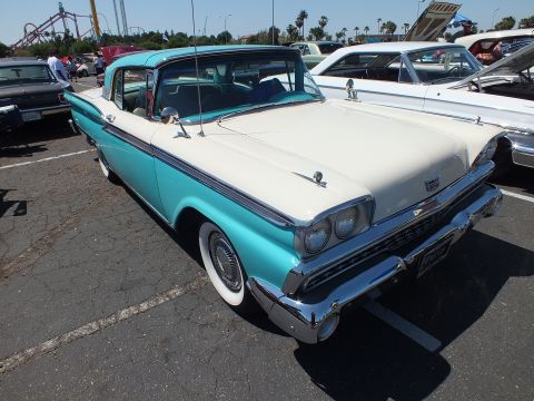 Turquoise and white 1959 Ford Fairlane sedan at outdoor car show