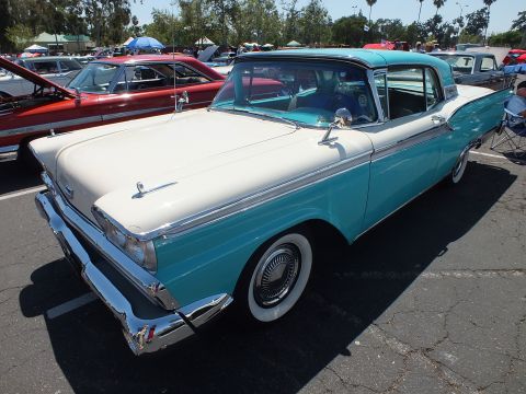 Two-tone turquoise and white 1959 Ford hardtop at sunny car show