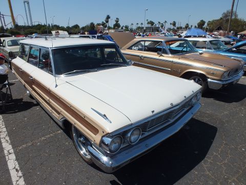 White and woodgrain 1964 Ford Country Squire station wagon at show