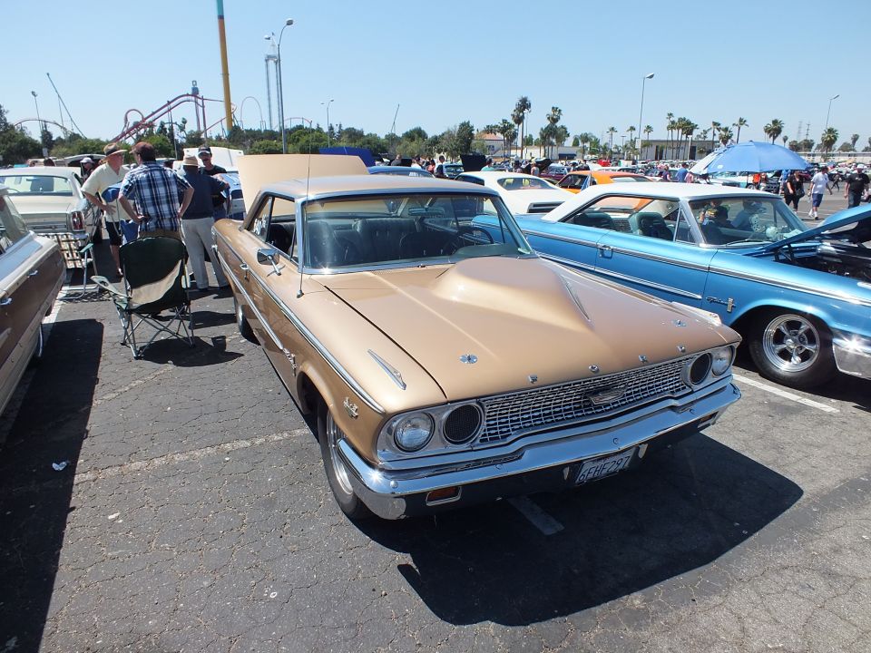 Gold 1963 Ford Galaxie hardtop with tan roof at outdoor car show