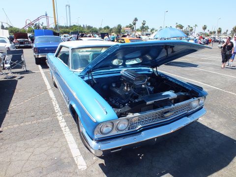Blue 1963 Ford Galaxie hardtop with white roof and hood up at show