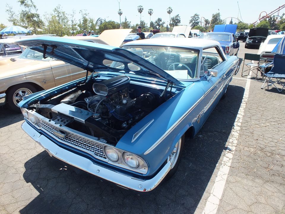 Blue 1963 Ford Galaxie hardtop with white roof and hood open at show