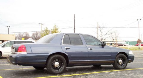 1998 Ford Crown Victoria - This blue 1998 Ford Crown Victoria sedan is seen from the side in a parking lot.