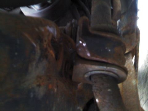 1999 Mercury Grand Marquis - Close-up view of rusty swaybar bushings and their mounting hardware.