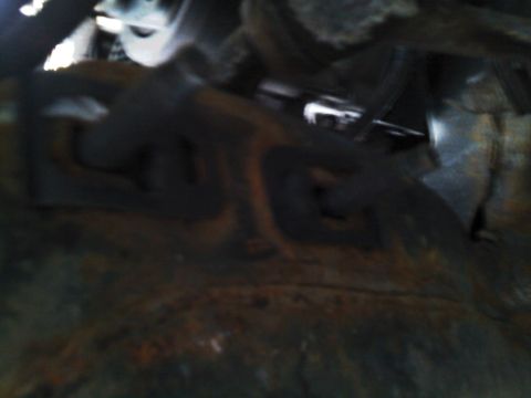 1999 Mercury Grand Marquis - Close-up of the underside of a vehicle, showing various mechanical parts and rust.