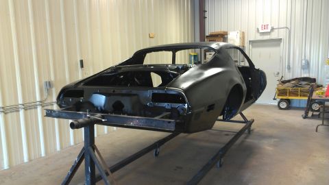 1972 Pontiac Trans Am - This car body, likely from the 1970s, is undergoing restoration in a workshop setting.
