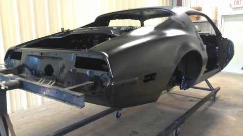 1972 Pontiac Trans Am - Body of a 1972 Pontiac Trans Am, primed black and mounted on a stand for restoration.