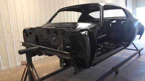 1972 Pontiac Trans Am - Unfinished car body shell on a restoration stand, showing the interior and front end.