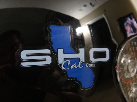 1995 Ford Taurus - A sticker reading SHO Cal.com is affixed to the black exterior of a vehicle.