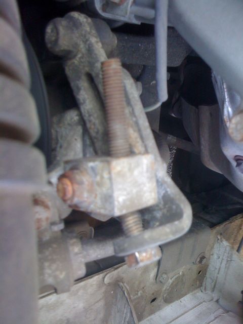 1991 Mazda Miata - Close-up view of a corroded AC bolt bracket, showing mechanical components.