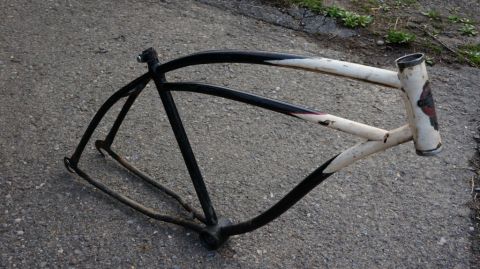 1994 Ford Bronco - This is a bicycle frame, not a 1994 Ford Bronco. It is painted black and white and shows signs of wear.