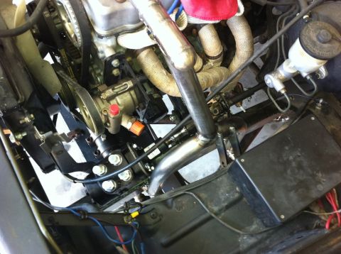 1987 Suzuki Samurai - Custom exhaust and engine components are visible in this engine bay photo.
