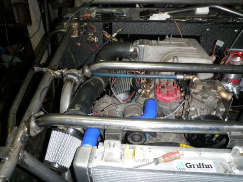 1961 International Scout 800 - Custom engine bay features a V8 engine, aftermarket intake, and roll cage. A Griffin radiator is installed.