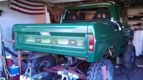 1967 Ford F-250 - This 1967 Ford F-250 pickup truck is shown from the rear, lifted and equipped with large off-road tires.