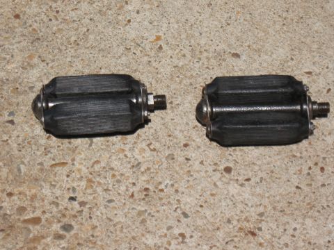 1994 Ford Bronco - A pair of bicycle pedals rests on a textured concrete background.