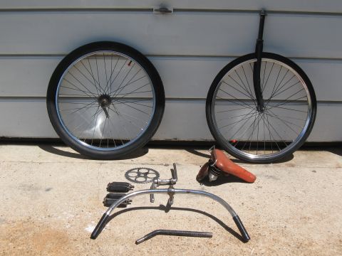 1994 Ford Bronco - Disassembled bicycle components including two wheels, pedals, chainring, handlebars, and a seat.