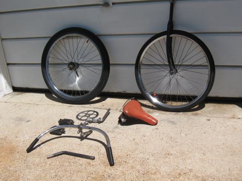 1994 Ford Bronco - Disassembled bicycle components are arranged on a concrete surface in front of a white wall.