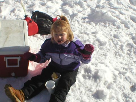 1978 Ford Bronco - A child sits in the snow with a cooler and a gas can, possibly after an outdoor activity.