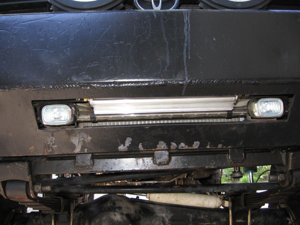 Black bumper with two fog lights and a chrome grille. Toyota badge visible above grille