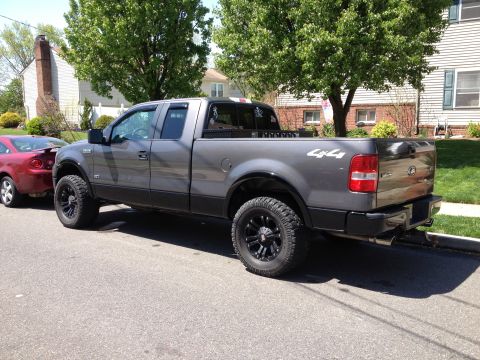 2008 Ford F-150 - This gray 2008 Ford F-150 pickup truck is shown from the rear three-quarter angle.