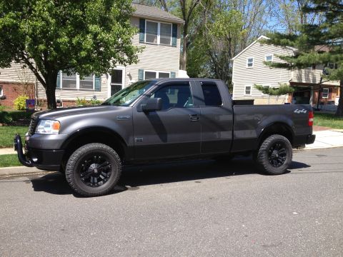 2008 Ford F-150 - Side view of a 2008 Ford F-150 pickup truck with aftermarket wheels and a bull bar.